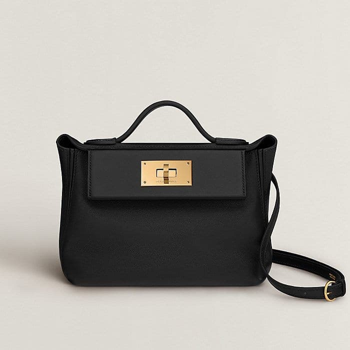 Black Hermès 24/24 bag on a neutral studio background