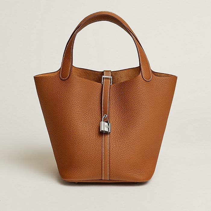 Gold-toned Picotin bag on a soft neutral background