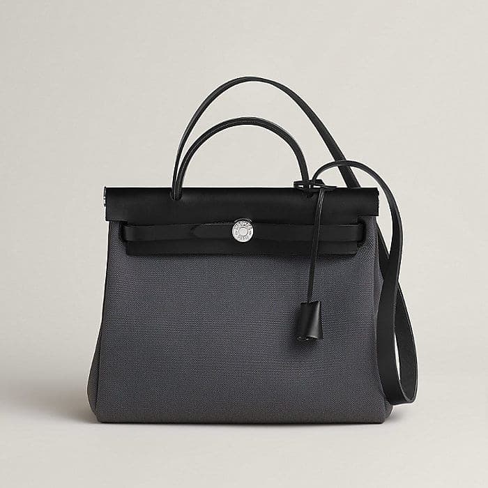 Black and gray Herbag with leather flap and canvas body